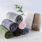 Dark green CUTEMATE plush pet fleece being placed inside a car seat for travel.
