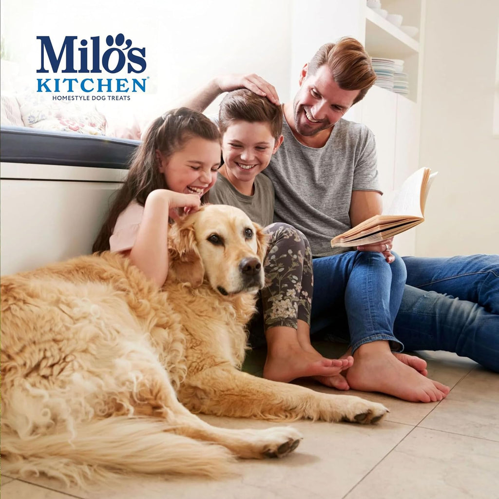Dog happily eating Milo's Kitchen chicken jerky strip