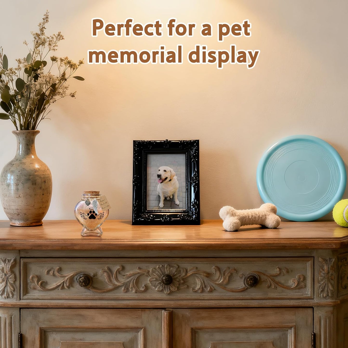 Heart shape glass memory jar filled with a soft tuft of pet fur on a desk
