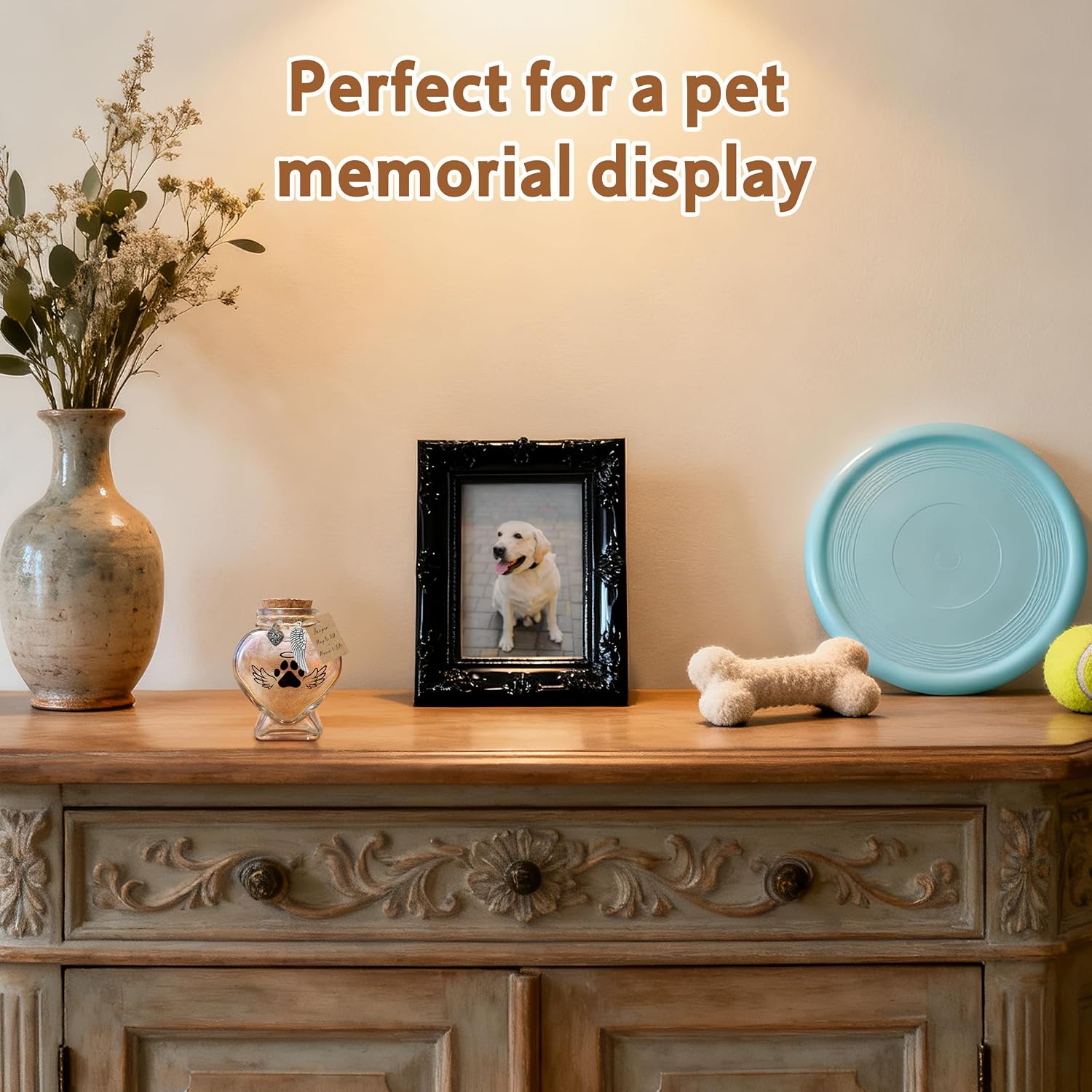 Heart shape glass memory jar filled with a soft tuft of pet fur on a desk