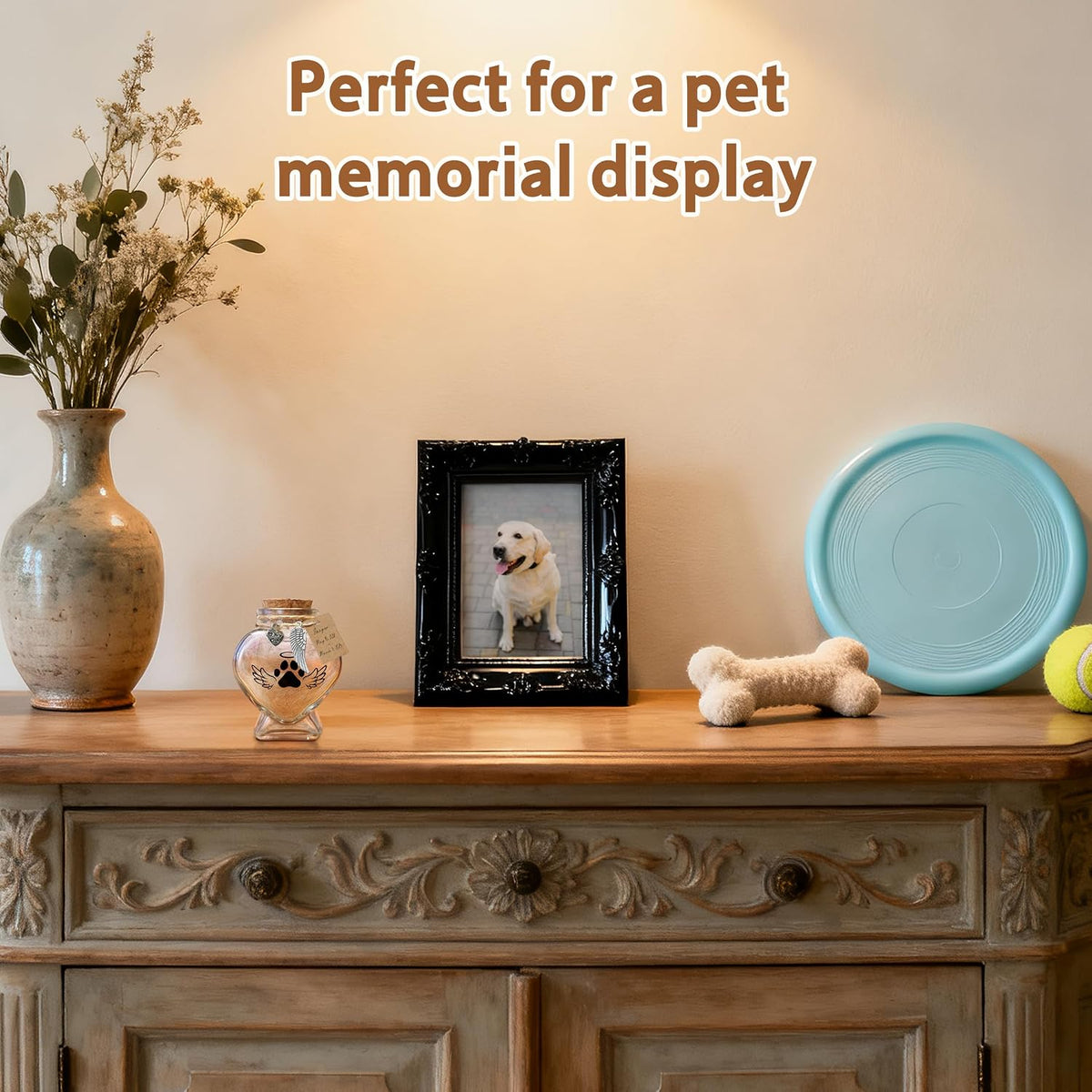 Heart shape glass memory jar filled with a soft tuft of pet fur on a desk