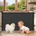 Cideny retractable baby gate front view installed in a wide wooden doorway.