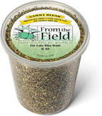 Natural organic catnip leaf and flower blend sprinkled on a wooden floor for feline enrichment.