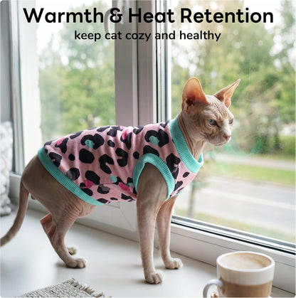 Hairless cat wearing pink pullover pajamas for temperature regulation