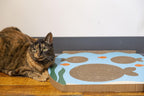 Reversible cardboard scratching mat for cats with underwater theme.