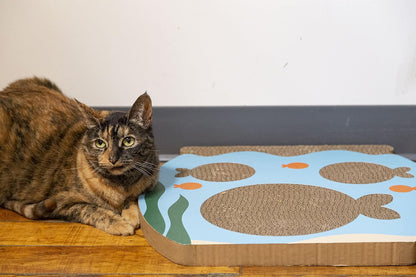 Reversible cardboard scratching mat for cats with underwater theme.