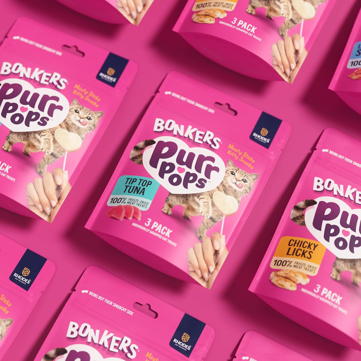 Tuna flavor cat candy lollipop treat being crumbled over dry kibble as a food topper.