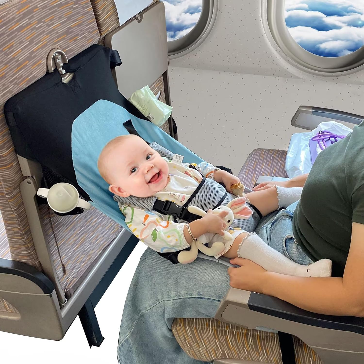 MueKeesam inflatable toddler travel bed front view showing the blue and black fabric hammock design installed on an airplane seat.