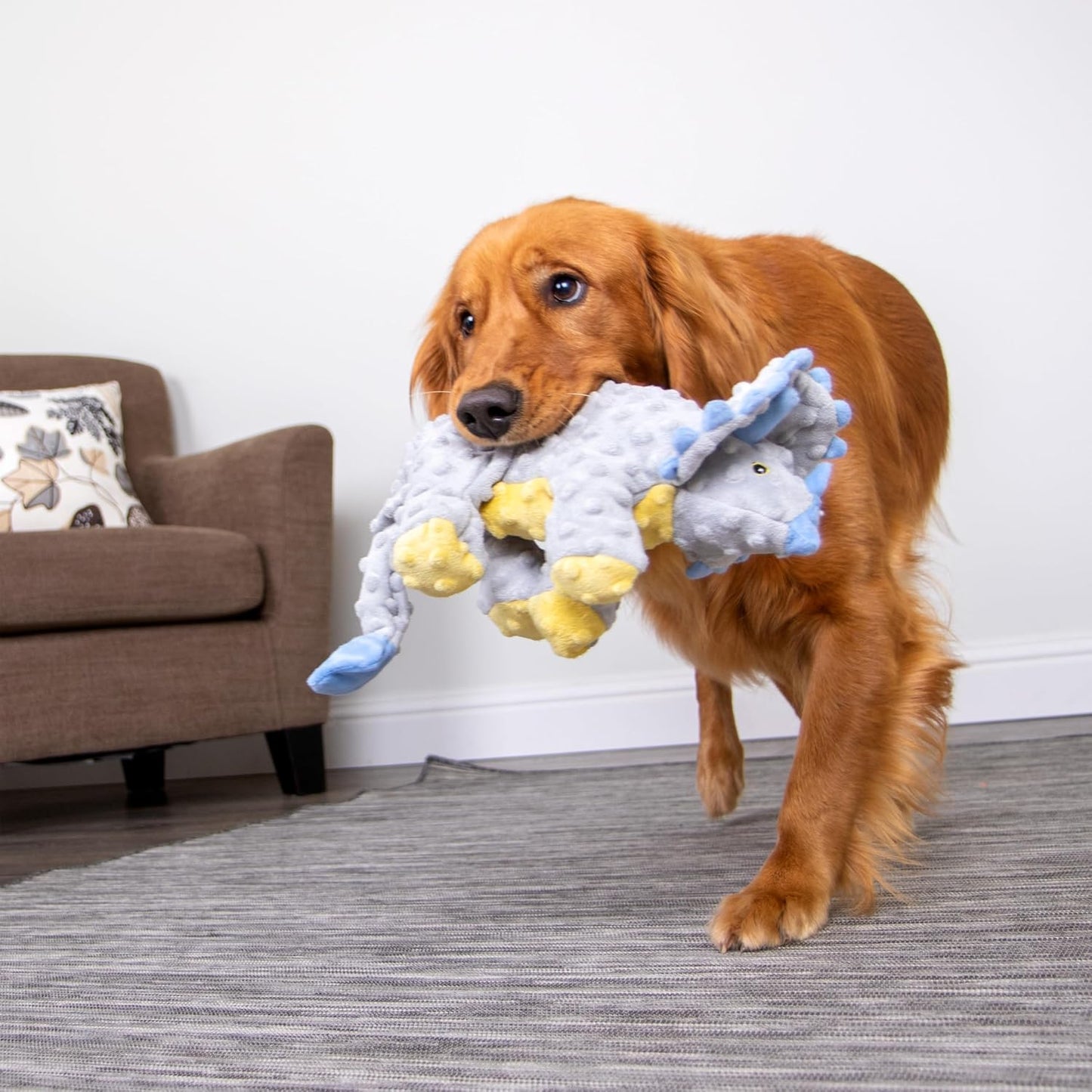 Heavy duty goDog large breed plush play toy on a clean surface backdrop