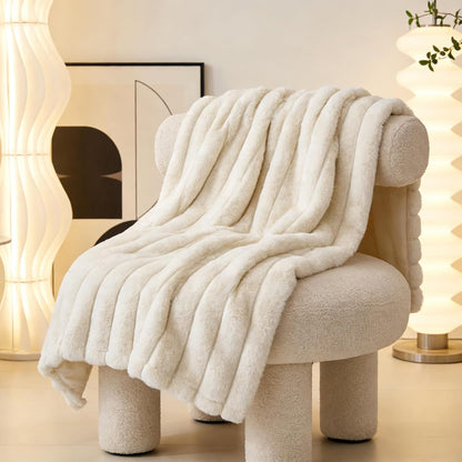 Zakapaws luxury plush dog blanket folded neatly on a white bedroom mattress.