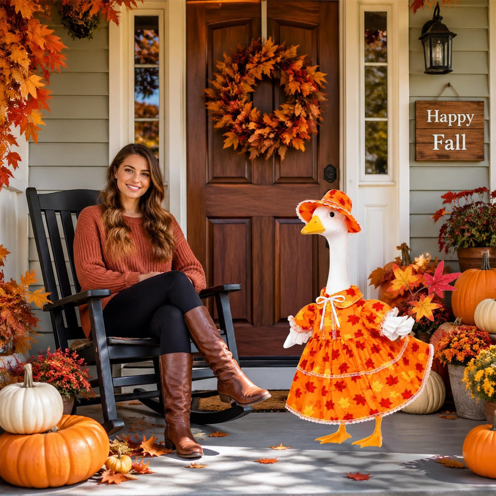 Autumn yard display showcasing the dressed plastic goose statue on a patio porch
