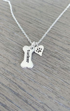 Detailed view of the 12 character engraved dog bone charm on silver chain