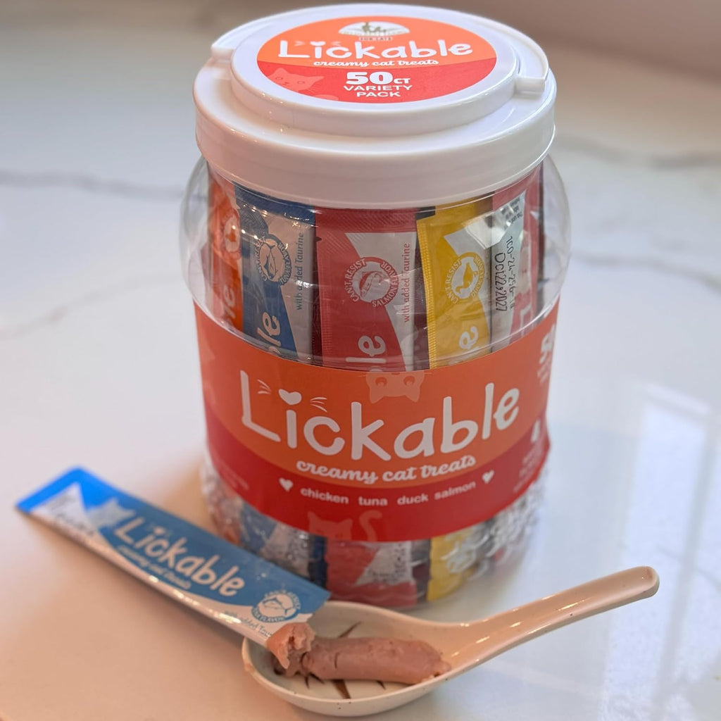 Owner hand feeding cat with Fieldcrest Farms lickable treat