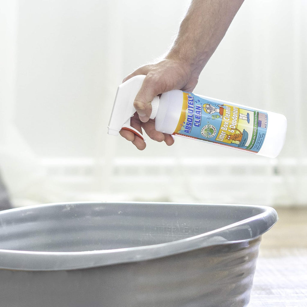 Pet owner using Absolutely Clean spray on cat litter pan