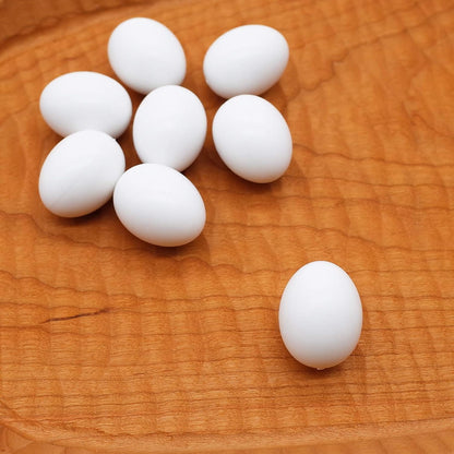 FOIBURELY fake hatching eggs displayed next to a measuring tool showcasing the small parrot scale.