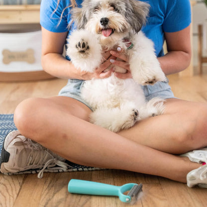 Side view of the lightweight Uproot Clean professional pet grooming brush showing blade curve