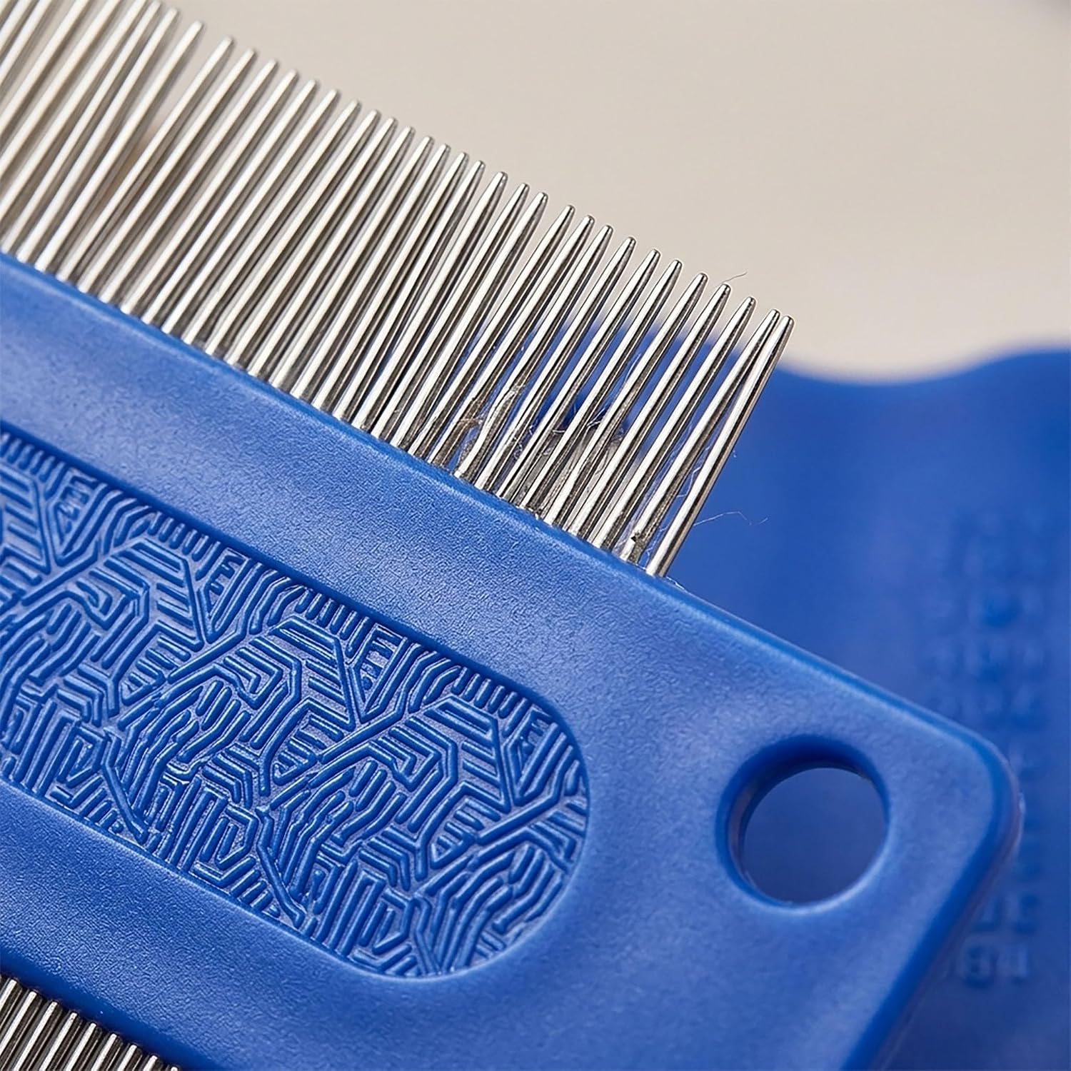 Side view of the ergonomic plastic finger grip on the blue KittuPet dog eye cleaning tool.