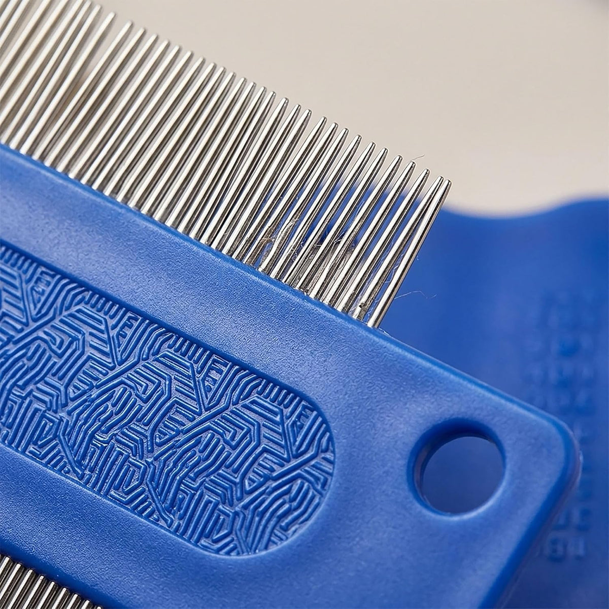 Side view of the ergonomic plastic finger grip on the blue KittuPet dog eye cleaning tool.