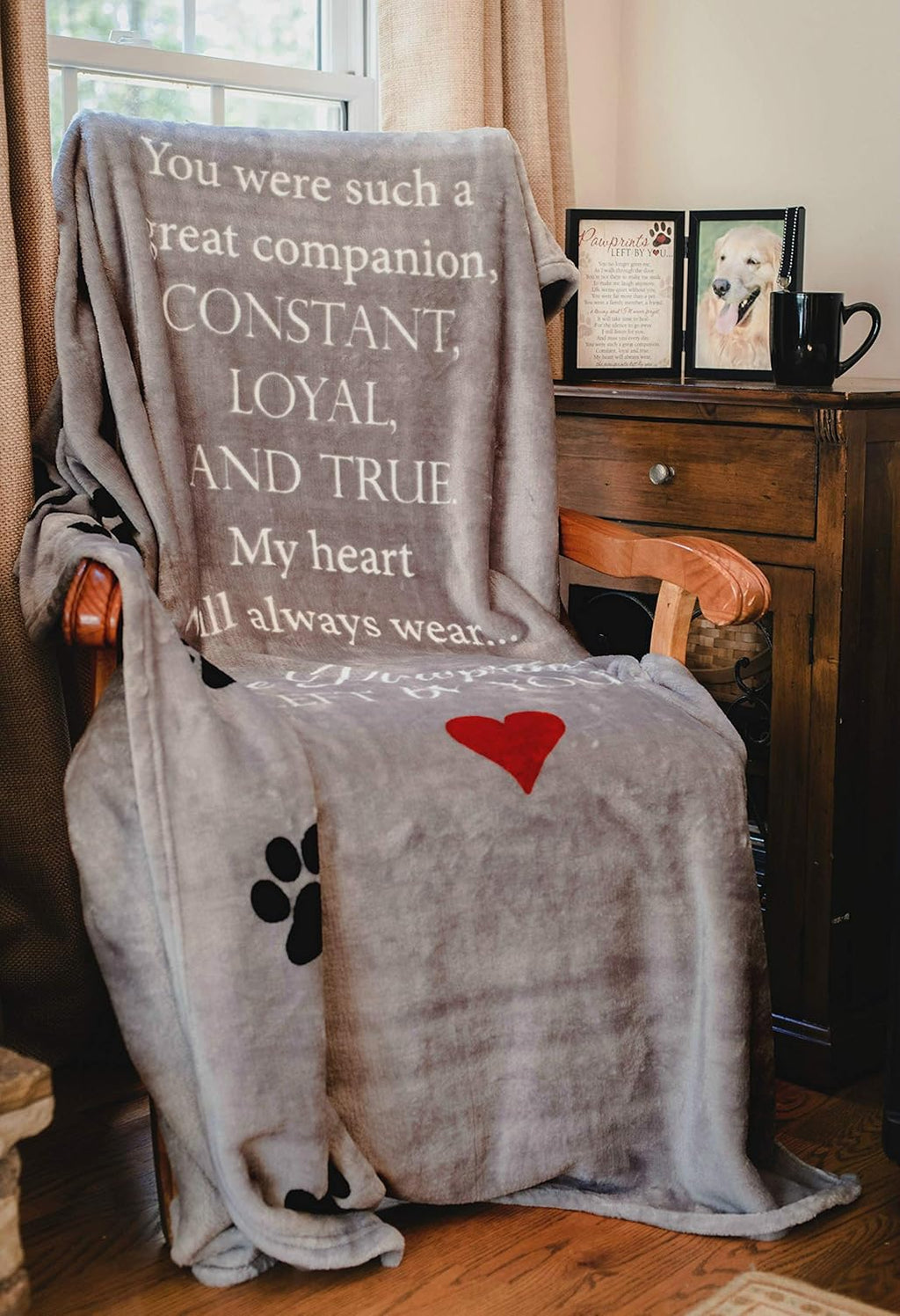 Sixty by fifty inches gray pet memorial throw blanket draped over a living room armchair.