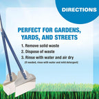 Four Paws yard cleaning rake and pan standing upright in a garden setting.