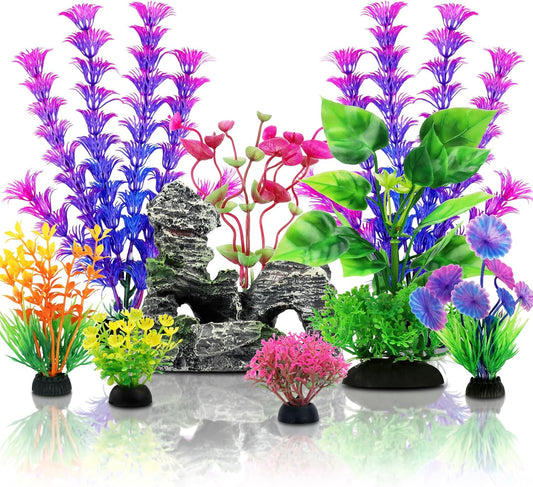 QUOZUO fish tank accessories set front view featuring colorful artificial plants and a resin cave rock.