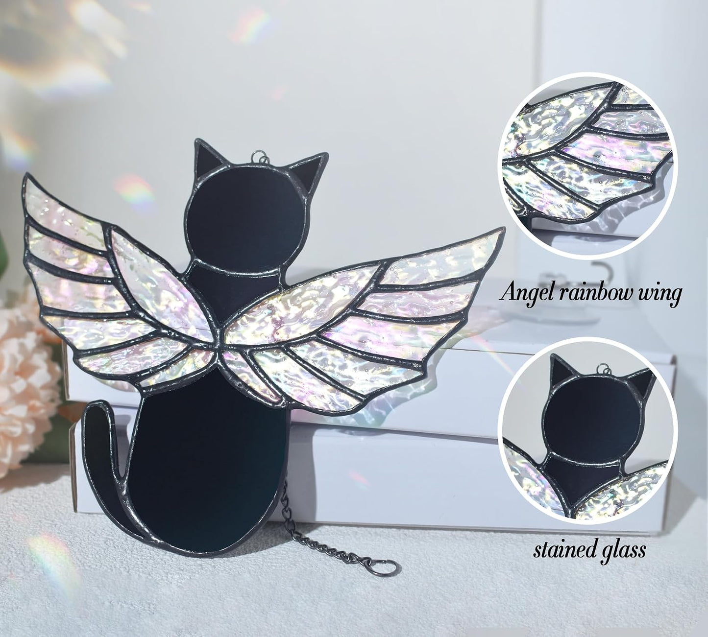 Handmade black cat memorial ornament with iridescent rainbow wings illuminated by sunlight