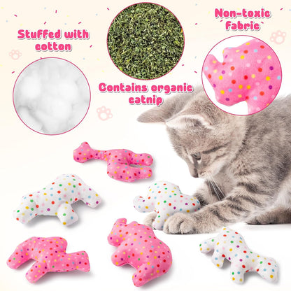 Cat playing with frosted animal cookie catnip toy on floor
