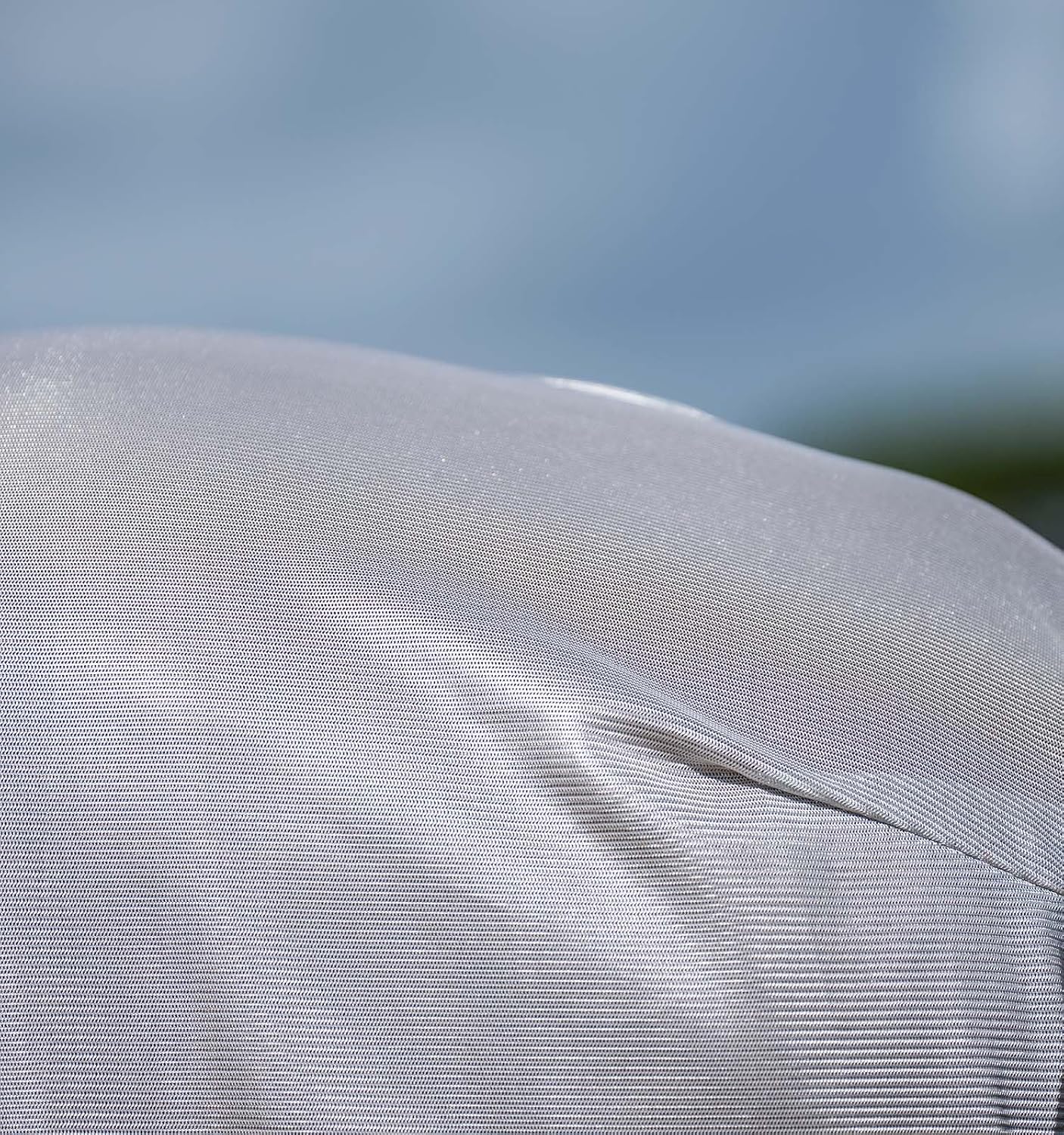 Close-up view of the breathable mesh weave and adjustable crossed surcingles on the Amigo horse protective blanket