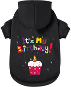 Small dog wearing GreenJoy black hooded sweatshirt outdoor