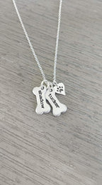 Handcrafted pet memorial jewelry set with two engraved bone nameplates