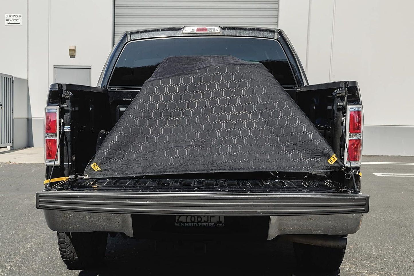 CAT outdoor tarp material blanket showing the water resistant brown and black fabric.