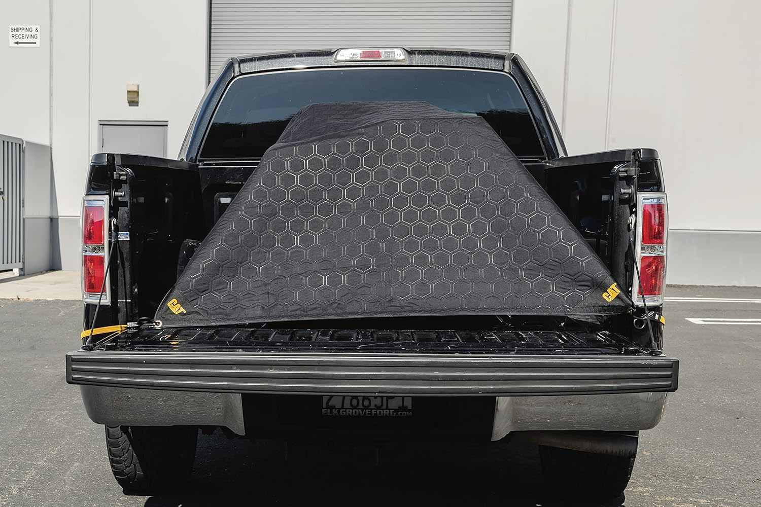 CAT outdoor tarp material blanket showing the water resistant brown and black fabric.