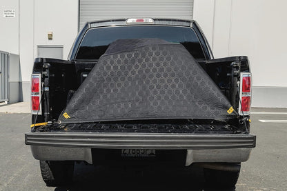 CAT outdoor tarp material blanket showing the water resistant brown and black fabric.