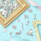 Detailed display of antique silver alloy charms including cat-on-moon designs