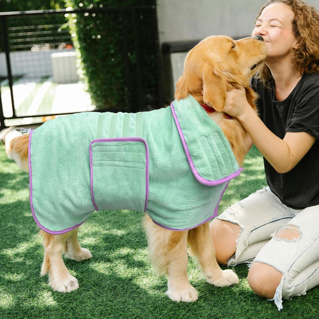 Large green dog bathrobe laid flat showing full body coverage design and purple trim detailing