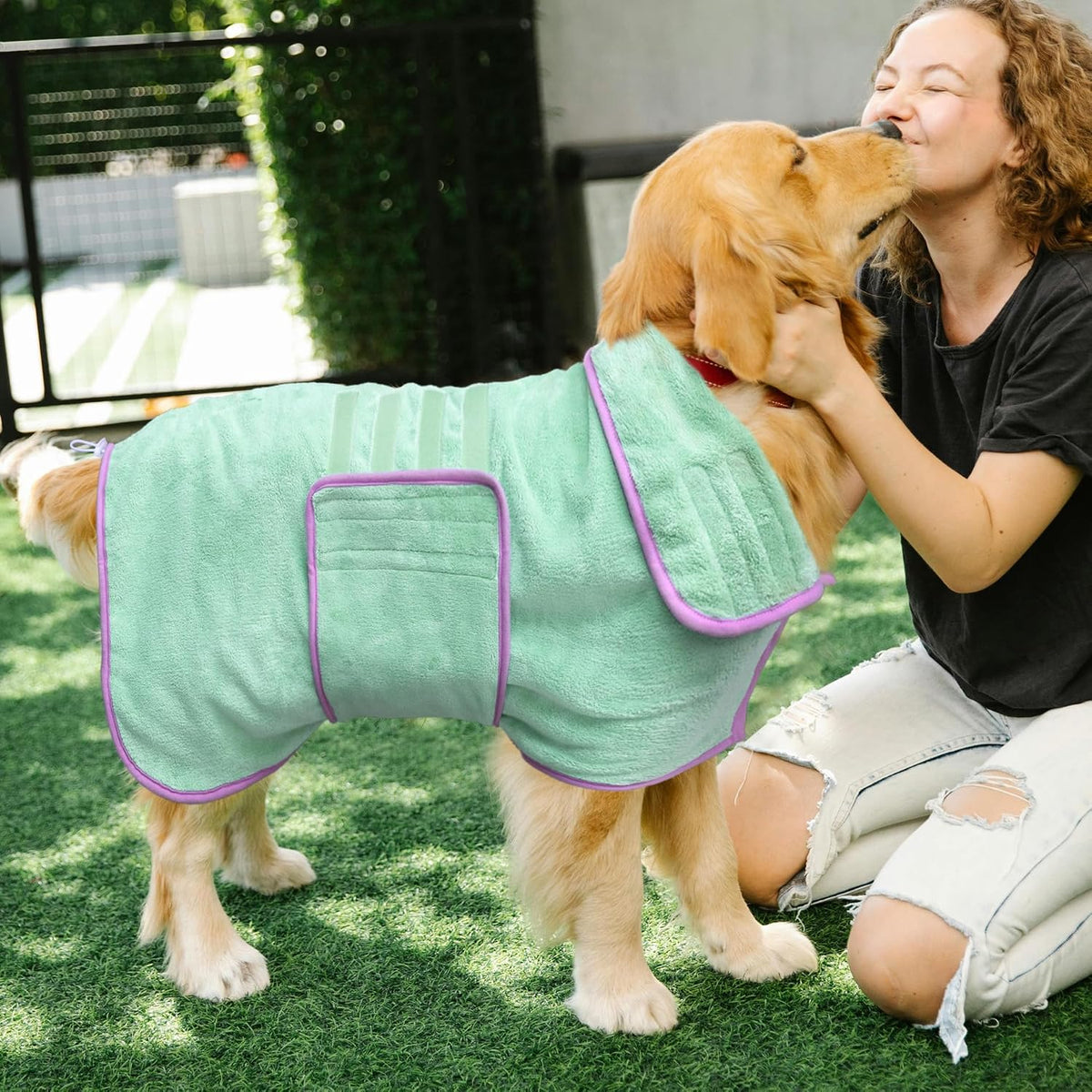 Large green dog bathrobe laid flat showing full body coverage design and purple trim detailing