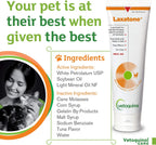 Cat licking tuna flavored hairball lubricant paste from paw