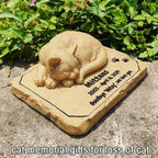 Sleeping cat sculpture detail on memorial stone marker