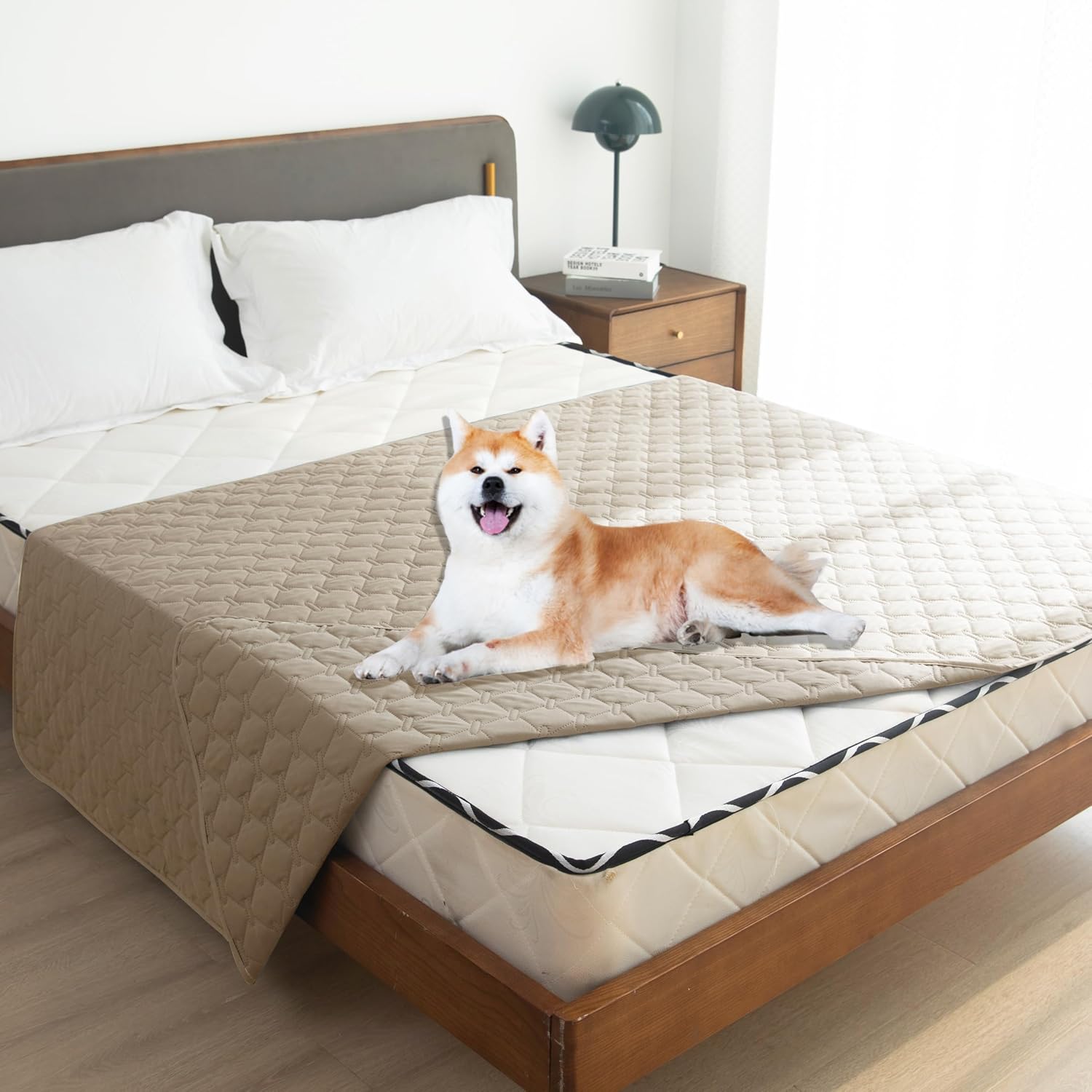 Reversible double sided waterproof dog blanket laid out on a large bed
