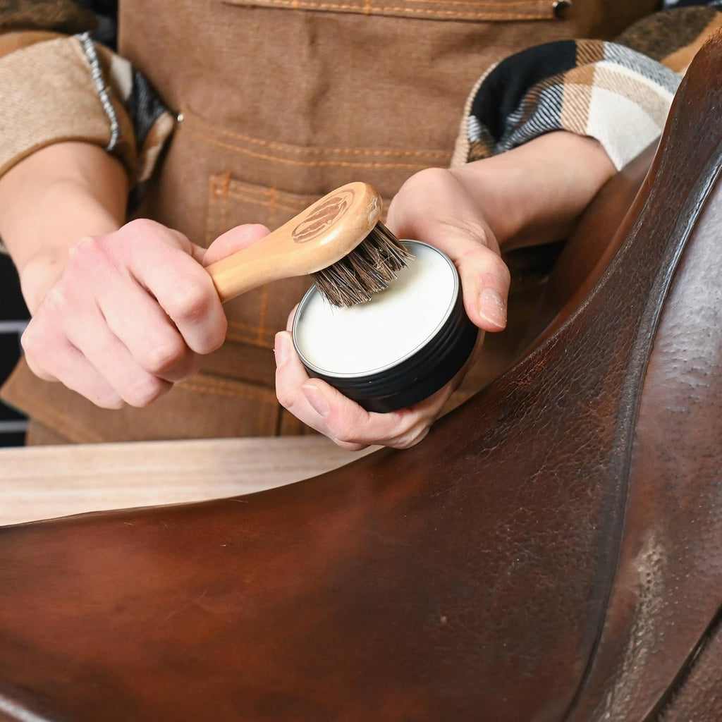 Rhino Wax leather conditioner tube alongside soft horsehair dauber application brushes.