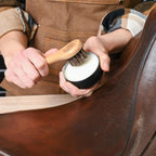 Rhino Wax leather conditioner tube alongside soft horsehair dauber application brushes.