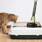 Heavy duty serrated scoop jaws picking up pet waste on grass surface