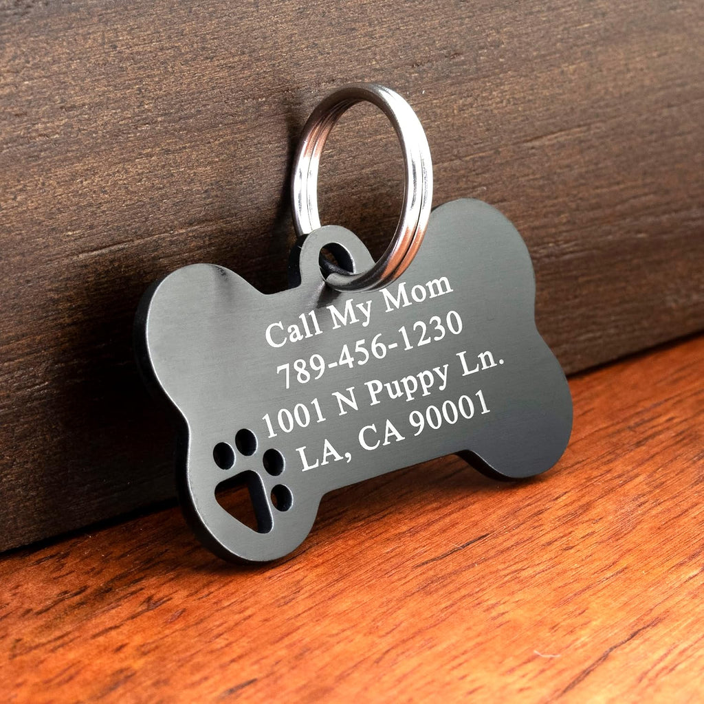 Ultra Joys stainless steel dog tag featuring the unique hollow paw cutout design detailing.
