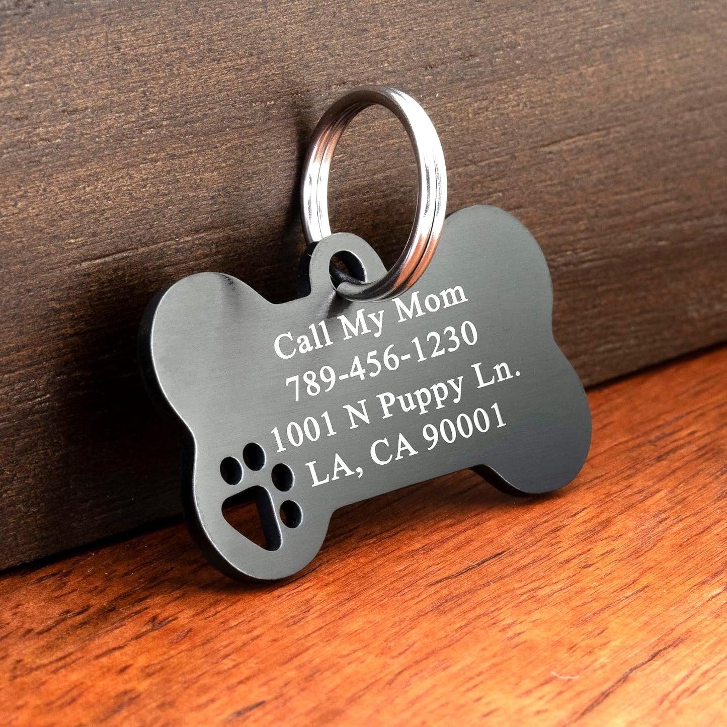 Ultra Joys stainless steel dog tag featuring the unique hollow paw cutout design detailing.