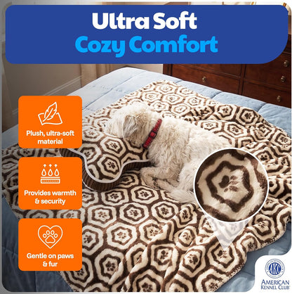 Reversible brown paw print dog blanket folded neatly next to the matching bone shaped plush pillow
