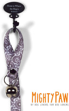 Mighty Paw Tinkle Bell 2.0 hanging from a door for pet training