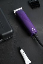 Durable hard storage case holding the purple professional animal clipper.