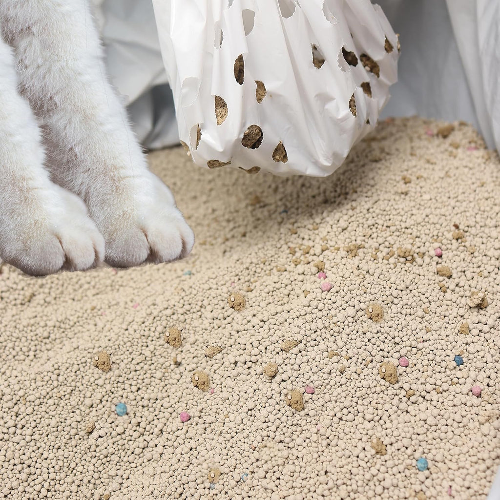 Clumping cat litter sifting through ninety-six filtration holes in white liner