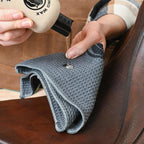 Applying natural wax leather care formula to a riding saddle using a microfiber towel.