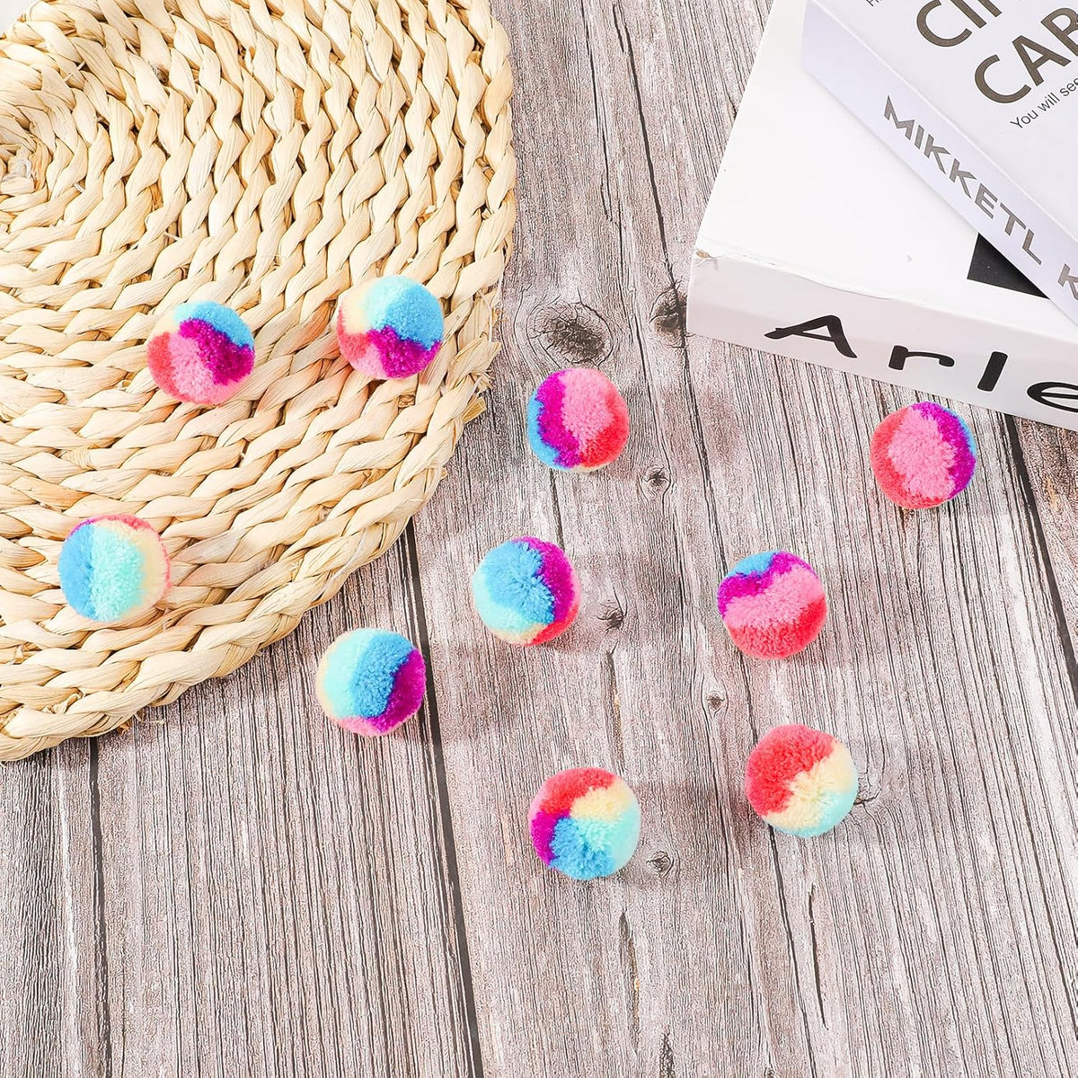 Top down view of 30 piece colorful cat pom pom ball collection